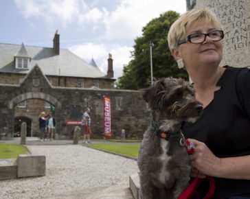 Spingo our museum dog and Mary the museum director sitting on the war memorial with the museum in the background