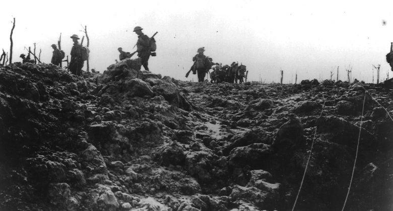 Soldiers march through a shelled battlefield.