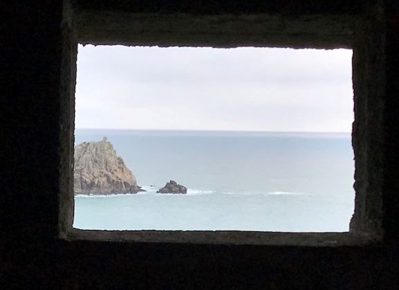 View through a pillbox window towards the sea and the Logan Rock near Porthcurno